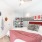 Large white bed with red accent