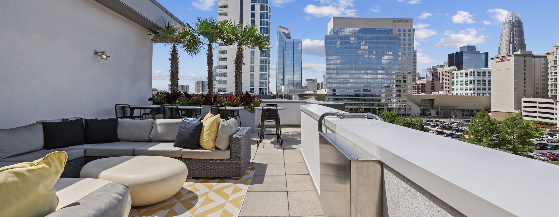 a balcony area with a couch, tables and chairs